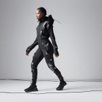 The figure strides confidently, clad in sleek, futuristic techwear matte black layers, reflective accents, and integrated gadgets hinting at a high-tech urban warrior.
